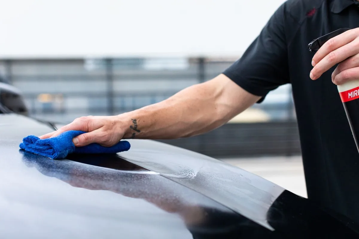 Applying protective wax to a car body